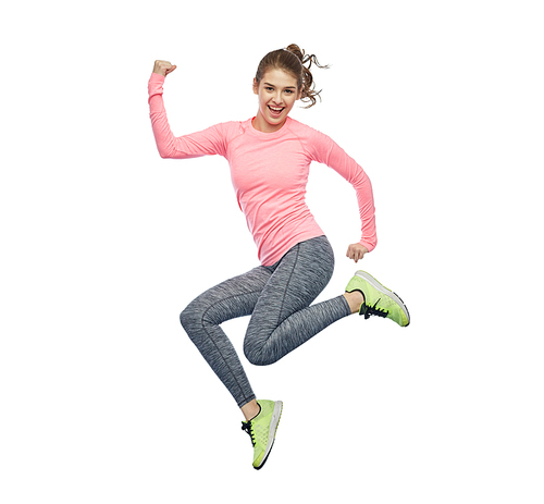 sport, fitness, motion and people concept - happy smiling young woman jumping in air and showing power gesture over white background