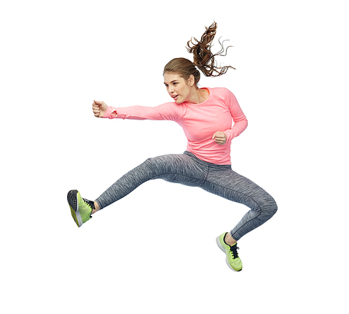 sport, fitness, motion and people concept - happy young woman jumping in air in fighting pose over white background