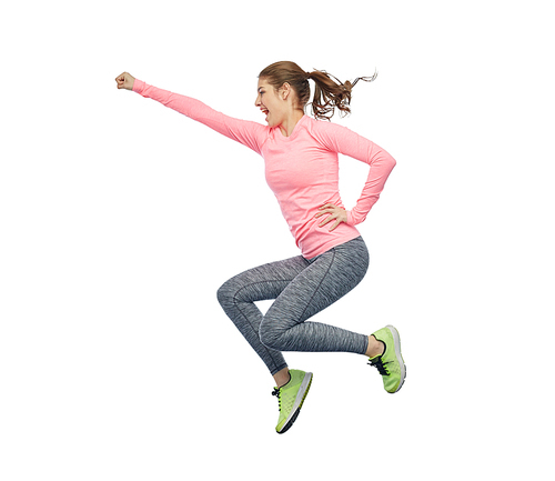 sport, fitness, motion and people concept - happy smiling young woman jumping in air and showing power gesture over white background