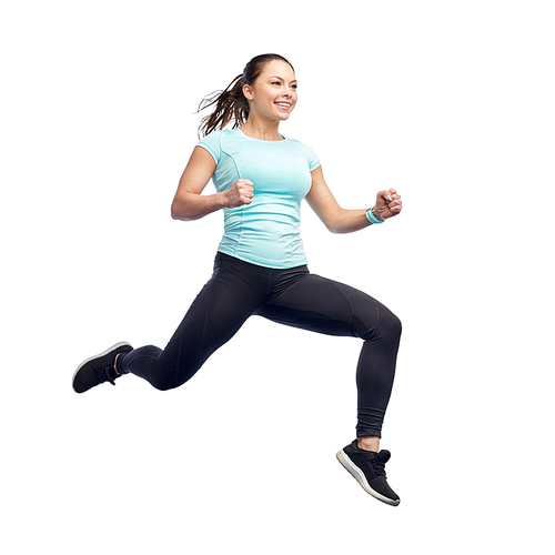 sport, fitness, motion and people concept - happy smiling young woman jumping in air over white background