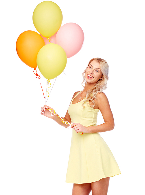 people, holidays and summer party concept - happy young woman or teen girl in pink dress with helium air balloons