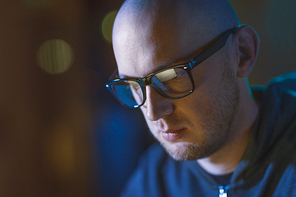 cybercrime, hacking and people concept - close up of bald hacker in glasses