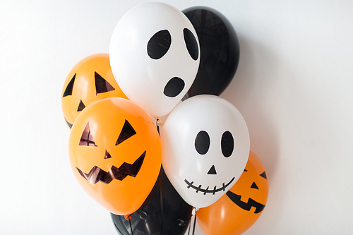 holidays, decoration and party concept - bunch of scary air balloons for halloween over white background