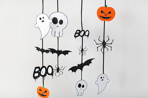 holidays and decoration concept - halloween paper party  decorations over white background