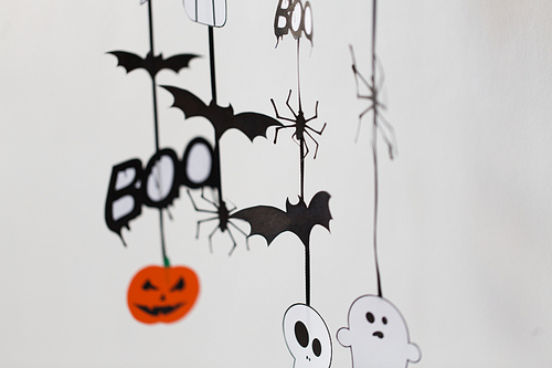 holidays and decoration concept - halloween paper party  decorations over white background