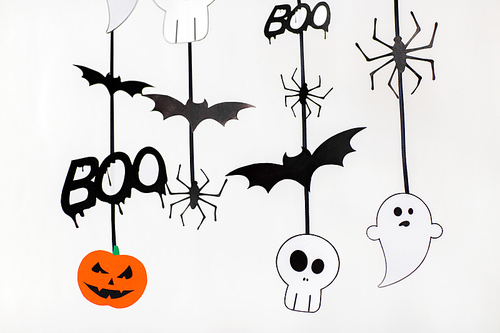 holidays and decoration concept - halloween paper party garlands over white background