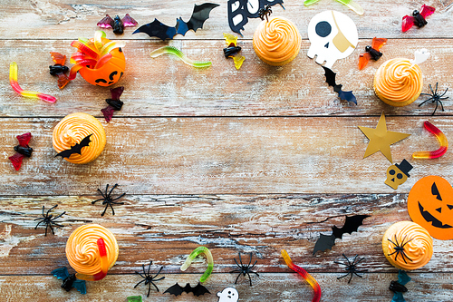 holidays, decoration and party concept - halloween paper decorations and treats with blank copy space over white background