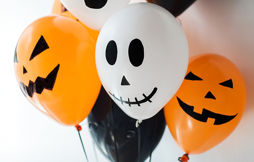 holidays, decoration and party concept - bunch of scary air balloons for halloween over white background