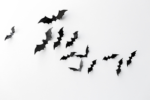 halloween and decoration concept -  paper bats flying over white background