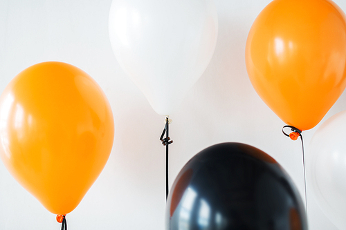 holidays, decoration and party concept - bunch of air balloons for halloween or birthday over white background