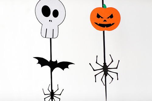 holidays and decoration concept - halloween paper party garlands over white background