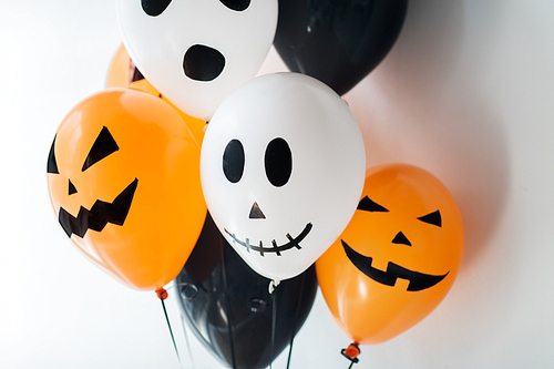 holidays, decoration and party concept - bunch of scary air balloons for halloween over white background