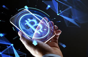 business, cryptocurrency and future technology concept - close up of hand with virtual bitcoin symbol hologram transparent smartphone screen over black background