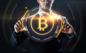 cryptocurrency, finance and business concept - close up of businessman with virtual bitcoin symbol hologram over black background