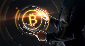 business, cryptocurrency and future technology concept - close up of businessman with transparent tablet pc computer and virtual bitcoin symbol hologram over black background