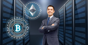 cryptocurrency, financial technology and business concept - businessman with ethereum and bitcoin holograms over server room background