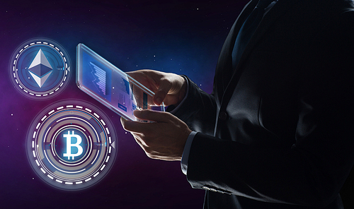 business, cryptocurrency and future technology concept - businessman with transparent tablet pc computer and virtual bitcoin and ethereum holograms over space background