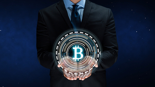 cryptocurrency, financial technology and business concept - close up of businessman with virtual bitcoin symbol hologram over space background