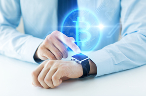business, technology and cryptocurrency concept - close up of male hand wearing smart watch with bitcoin on screen