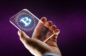 business, cryptocurrency and future technology concept - close up of businessman hand with charts on transparent smartphone and bitcoin hologram over ultra violet space background
