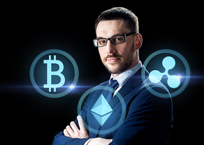 cryptocurrency, financial technology and business concept - buisnessman with virtual bitcoin, ethereum and ripple icons over dark background