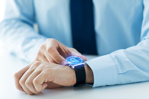business, technology and cryptocurrency concept - close up of male hand wearing smart watch with bitcoin on screen