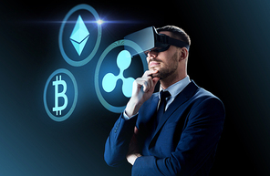cryptocurrency, financial technology and business concept - businessman in virtual reality headset with ethereum, bitcoin and ripple holograms over dark background