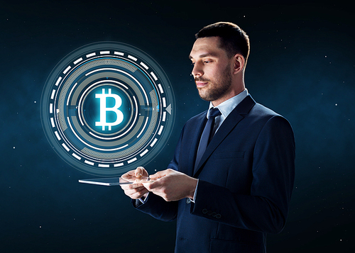business, cryptocurrency and future technology concept - businessman with transparent tablet pc computer and virtual bitcoin symbol hologram over space background