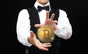 cryptocurrency, financial technology and business concept - close up of magician with bitcoin making trick over black background