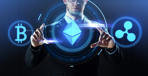 cryptocurrency, financial technology and business concept - close up of businessman with bitcoin, ethereum and ripple icons on virtual screen over dark background