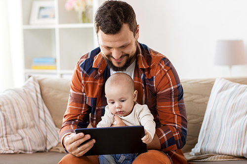 family, parenthood and people concept - happy father and little baby boy with tablet pc computer at home