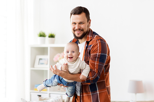 family, parenthood and people concept - happy father playing with little baby boy at home