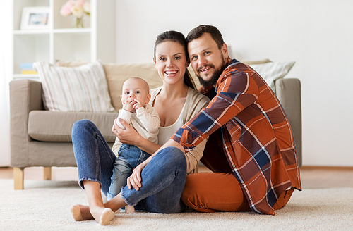 family, parenthood and people concept - happy mother, father with baby at home