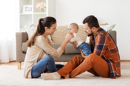 family, parenthood and people concept - happy mother, father with baby at home