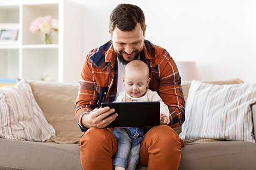 family, parenthood and people concept - happy father and little baby boy with tablet pc computer at home