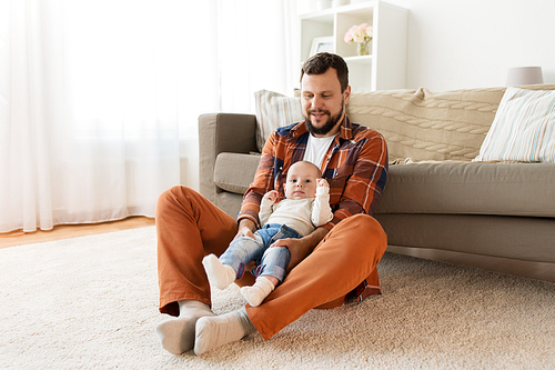 family, parenthood and people concept - happy father with little baby boy at home