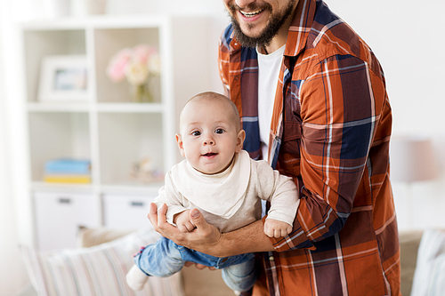 family, parenthood and people concept - close up of happy father playing with little baby boy at home