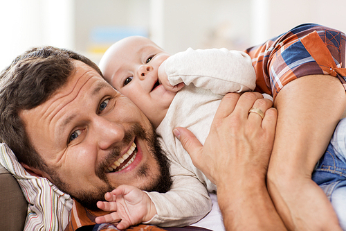 family, parenthood and people concept - close up of happy father with little baby boy at home