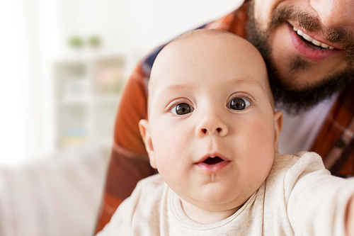 family, childhood, babyhood and people concept - close up of happy little baby boy with father at home