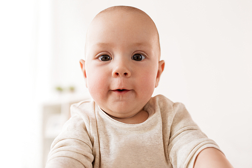 childhood, babyhood and people concept - close up of happy little baby boy face