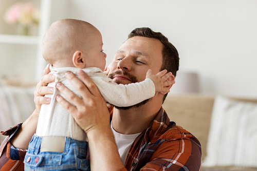 family, parenthood and people concept - happy father with little baby boy at home