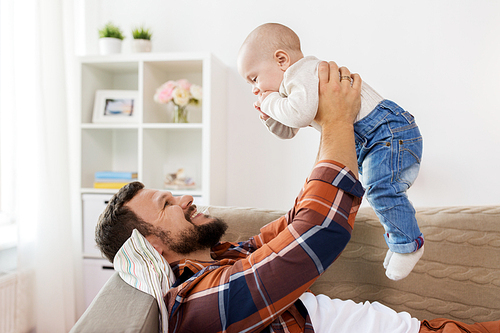 family, parenthood and people concept - happy father with little baby boy at home