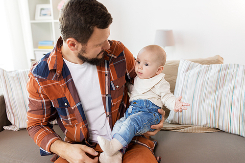 family, parenthood and people concept - happy father with little baby boy at home