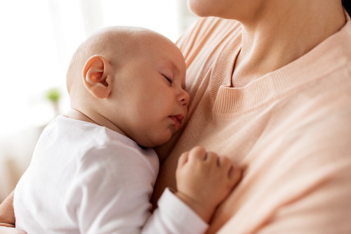family, motherhood and people concept - close up of mother holding sleeping little baby boy