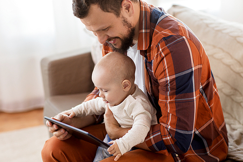 family, parenthood and people concept - close up of happy father and little baby boy with tablet pc computer at home