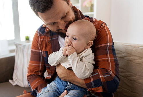 family, parenthood and people concept - close up of happy father with little baby boy at home