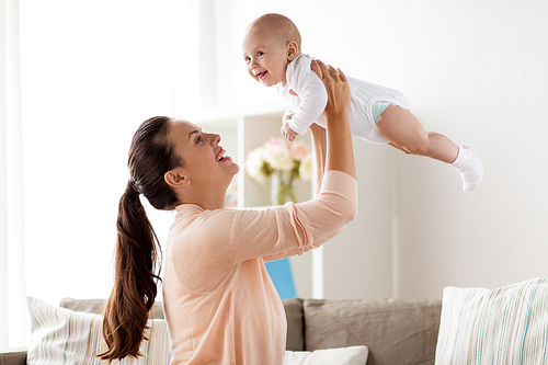 family, motherhood and people concept - happy mother playing with little baby boy at home