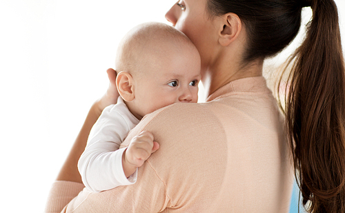 family, motherhood and people concept - close up of little baby boy with mother