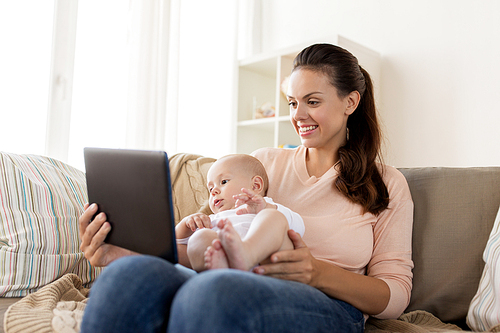 family, motherhood, technology and people concept - happy mother and little baby boy with tablet pc computer at home