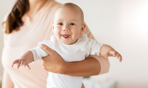 family, motherhood and people concept - close up of mother with little baby boy at home